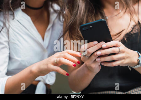 Woman's hands holding smartphone, close-up Stock Photo