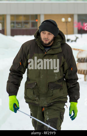 Portrait of a worker at an assembly site of an ice town in winter overalls Stock Photo