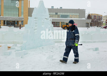 Portrait of a worker at an assembly site of an ice town in winter overalls Stock Photo