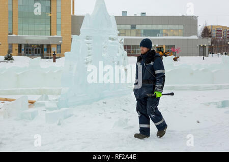 Portrait of a worker at an assembly site of an ice town in winter overalls Stock Photo