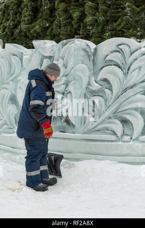 Portrait of a worker at an assembly site of an ice town in winter overalls Stock Photo