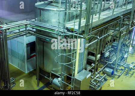 Metal reservoirs at a soft drink factory Stock Photo