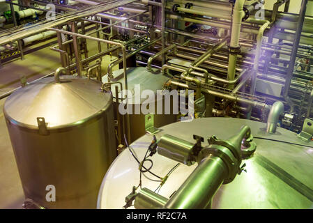 Metal reservoirs at a soft drink factory Stock Photo