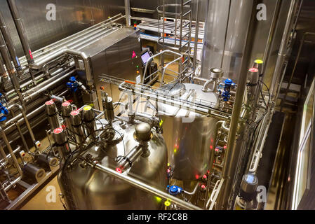 Metal reservoirs at a soft drink factory Stock Photo