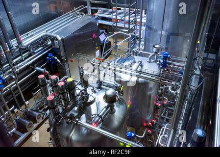 Metal reservoirs at a soft drink factory Stock Photo