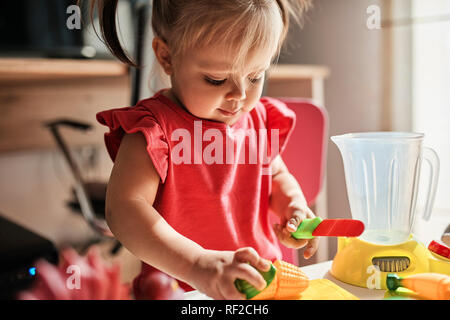 Little girl playing at home Stock Photo