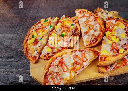 Homemade slices of pizza on peel with ingredients Stock Photo