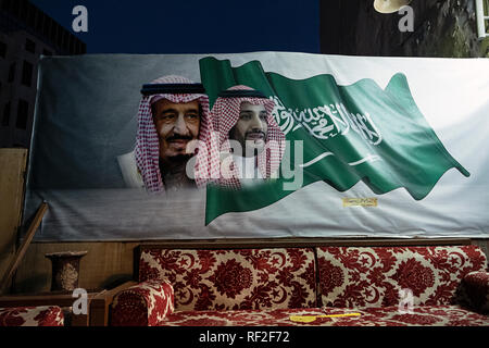 mural of King Salman and Crown Prince Mohammed Bin Salman draped above a traditional Bedouin style couch in Al Balad, Saudi Arabia Stock Photo