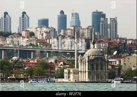 Mecidiye Mosque, Ortakoy district at the Bosporus, Skyline of the modern Istanbul in the back, Turkey Stock Photo