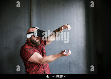 Bearded man wearing VR glasses Stock Photo