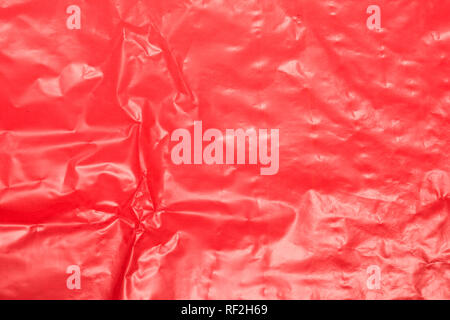 Wrinkled red plastic sheet for background or text. Stock Photo