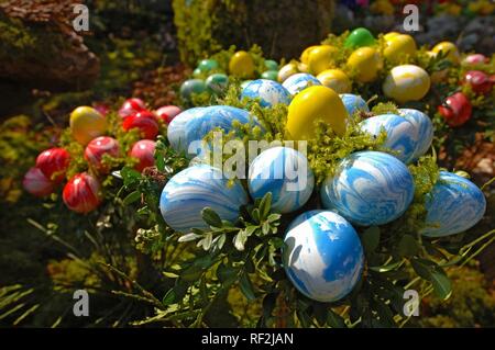 Easter decorations (easter eggs) on a fountain, Bieberach, Franconian Switzerland region, Bavaria Stock Photo