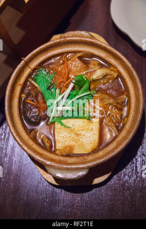 Japanese nabemono hotpot dish of seafood, tofu and vegetable boiled in water served with dipping sauce, known as Shabu-shabu. Cook meat piece by piece Stock Photo