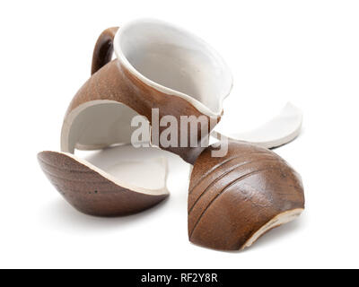 Broken ceramic jug on a white background. Stock Photo
