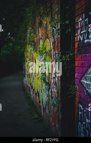 A colorful brick graffiti wall in a Berlin park. Stock Photo