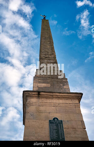 Ripon Market Place, Ripon, N Yorkshire, UK. 3rd July 2017. Early evening and the Obelisk and weather vane stand proud against a blue and clouded sky Stock Photo