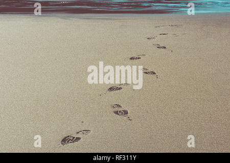 shoe prints in the sand on Trebarwith strand beach Stock Photo