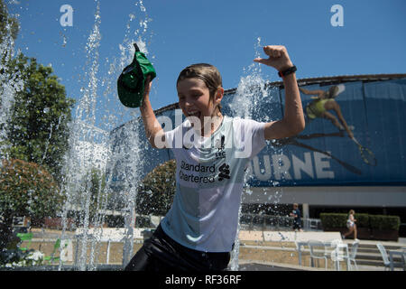 Melbourne, Australia. 24th Jan, 2019. A spectator plays at a fountain during the 2019 Australian Open in Melbourne, Australia, on Jan. 24, 2019. The Melbourne Park witnessed hot weather here on Thursday. Credit: Lui Siu Wai/Xinhua/Alamy Live News Stock Photo