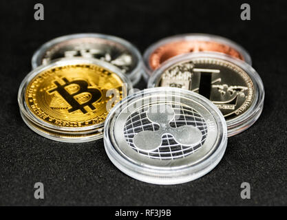 Five crypto currency coins on a black background. Stock Photo