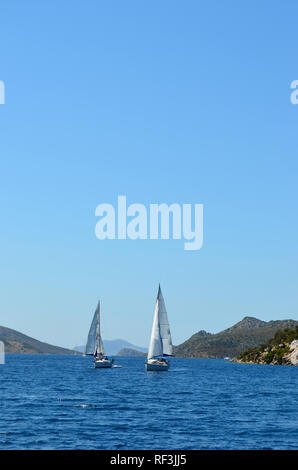 Sailing luxury boats participate in sail yacht regatta in the Aegean Sea in Turkey Stock Photo