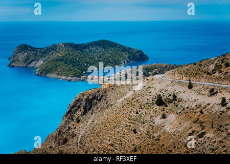 Mountain road leading to famous Assos village and venetian fortress, great landscape of Kefalonia island, Greece. Vacation summer holidays in Europe Stock Photo