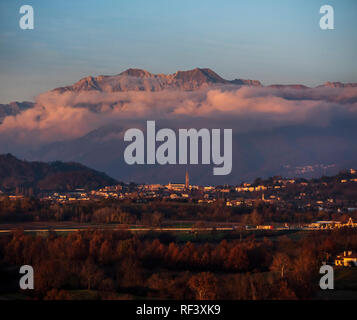 View of Monte Chiampon (Friuli - Italy) at sunset, with the village of Buja in foreground. Stock Photo