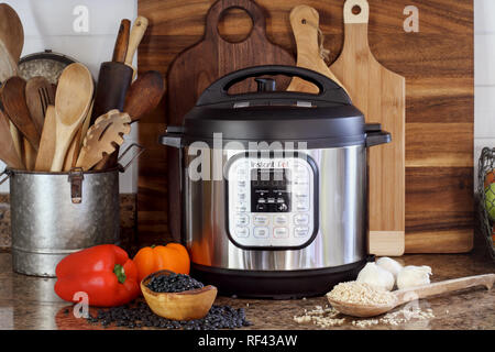 Breeding, KY, USA - January 08, 2019: Instant Pot pressure cooker on kitchen counter with beans and rice. Stock Photo