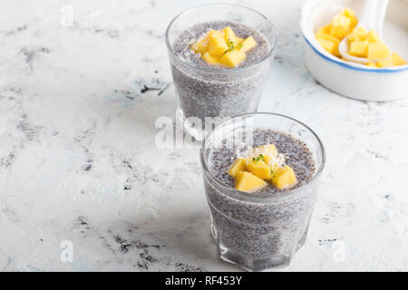 Mango chia pudding almond milk in glasses, healthy  breakfast meal, delicious dessert or snack Stock Photo
