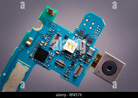 Blue circuit board from smartphone with camera module on a ribbon cable Stock Photo