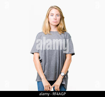 Beautiful young woman wearing oversize casual t-shirt over isolated background depressed and worry for distress, crying angry and afraid. Sad expressi Stock Photo