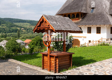 Barsana Monastery Architectural Detail - Traditional Wooden Fountain (Maramures, Romania). Stock Photo