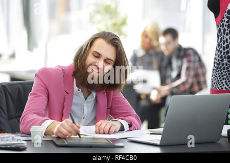 Fashion designer at the table in a modern Studio Stock Photo