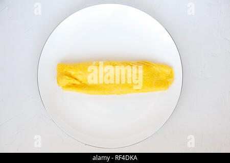 Simple french egg omelette on white background. Stock Photo