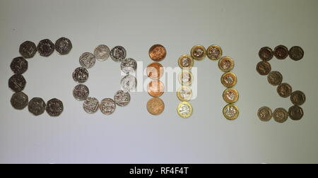 Sterling currency coins laid out to spell the word coins Stock