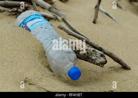 Plastic pollution, close-up, detail, single empty PET water bottle washed up beach of Durban, KwaZulu-Natal, South Africa, packaging Stock Photo
