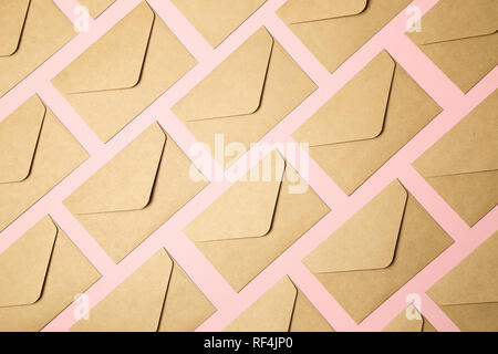 kraft brown paper envelopes on pink background Stock Photo