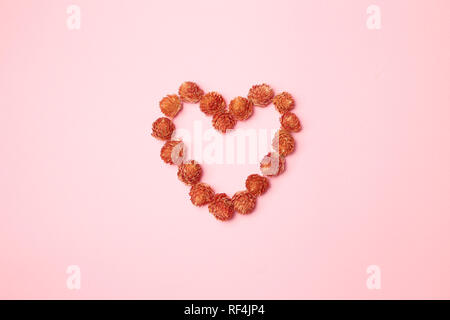 Love heart shaped red dry flower decoration Stock Photo