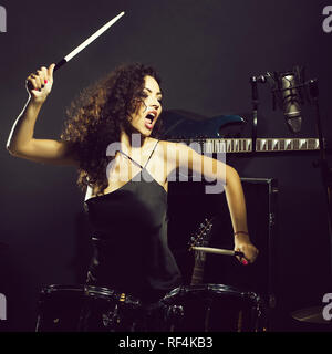 Woman playing drums Stock Photo