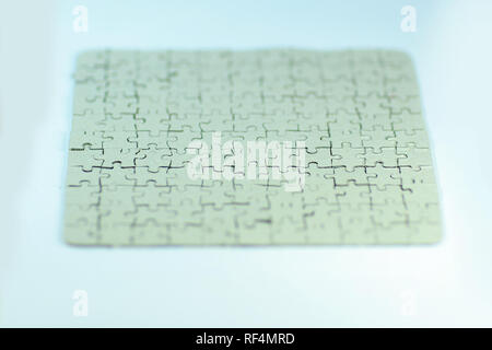 close up. blank card collected from puzzle pieces on a white sheet Stock Photo