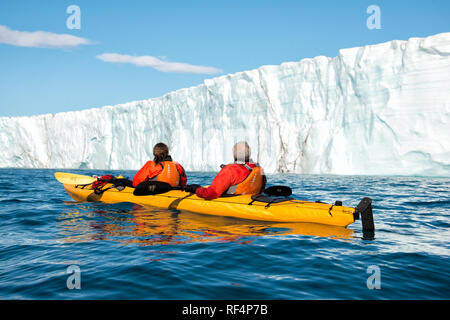 BRASVELLBREEN GLACIER, Svalbard — Kayakers navigate the icy waters near the Brasvellbreen glacier, one of the most impressive glaciers in the Svalbard archipelago. This unique kayaking experience offers visitors a close encounter with the Arctic landscape, highlighting the vast and awe-inspiring natural beauty of the region. Stock Photo