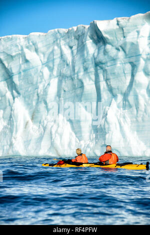 BRASVELLBREEN GLACIER, Svalbard — Kayakers navigate the icy waters near the Brasvellbreen glacier, one of the most impressive glaciers in the Svalbard archipelago. This unique kayaking experience offers visitors a close encounter with the Arctic landscape, highlighting the vast and awe-inspiring natural beauty of the region. Stock Photo