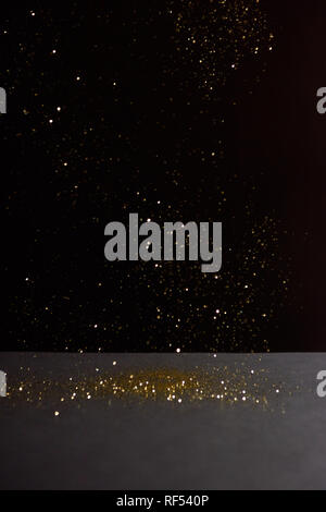 grey stone table with bright sparkles isolated on black Stock Photo