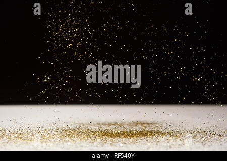 white table with bright sparkles isolated on black Stock Photo