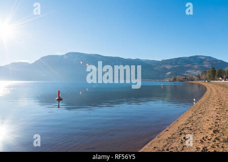 Sun shining on Skaha Beach, lake, and mountains in Penticton, British Columbia, Canada Stock Photo