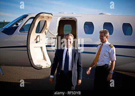 Businessman and a pilot standing in front of a private jet Stock Photo