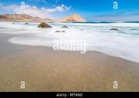 'Playa Blanca' in 'Pan de Azucar' National Park in North Chile with the Atacama Desert sands ending on the Pacific Ocean waters. An awe wild beach Stock Photo