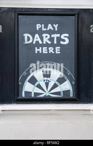 Closeup of a Play Darts Here chalk dart board outside a pub in London, England, UK Stock Photo