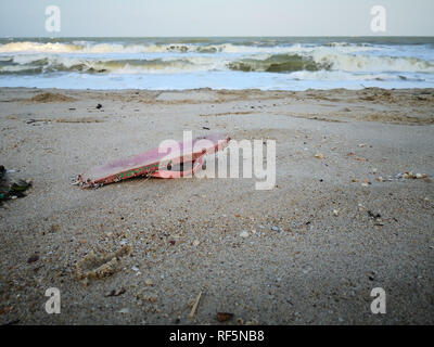 Pink slipper garbage washes up on Songkhla beach. Stock Photo