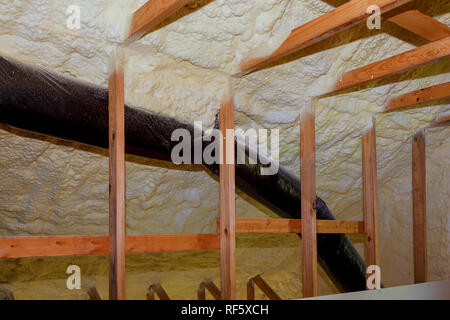 Foam plastic insulation installed in the sloping ceiling of new frame house. Stock Photo