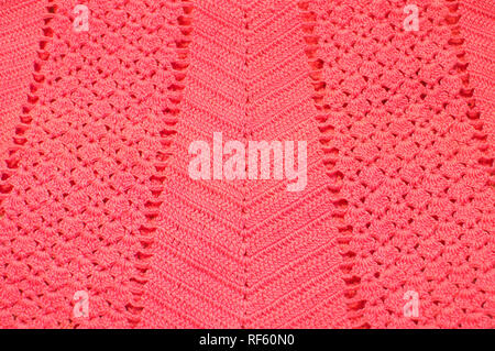 Pattern on a crocheted garment in Living Coral, the colour of the year for 2019. Stock Photo